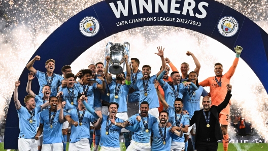 (FILES) Manchester City's German midfielder #8 Ilkay Gundogan holds aloft the European Cup trophy as they celebrate winning the UEFA Champions League final football match between Inter Milan and Manchester City at the Ataturk Olympic Stadium in Istanbul, on June 10, 2023. Manchester City won the match 1-0. (Photo by Paul ELLIS / AFP)