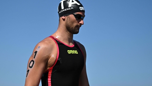 Italy's Domenico Acerenza arrives for the start of the final of the men's 5km open water swimming event during the 2024 World Aquatics Championships at Doha Port in Doha on February 7, 2024. (Photo by MANAN VATSYAYANA / AFP)