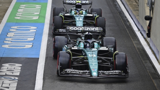 Aston Martin driver Lance Stroll of Canada and Aston Martin driver Fernando Alonso of Spain, rear, steer their cars before the qualifying session at the British Formula One Grand Prix at the Silverstone racetrack, Silverstone, England, Saturday, July 8, 2023. The British Formula One Grand Prix will be held on Sunday. (Christian Bruna/Pool photo via AP)