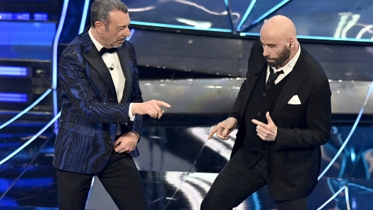 John Travolta and Amadeus perfermer during the 74th edition of the SANREMO Italian Song Festival at the Ariston Theatre in Sanremo, northern Italy - Tuesday, FEBRUARY 7, 2024. Entertainment. (Photo by Marco Alpozzi/LaPresse)  