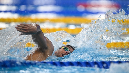 Italy's Gregorio Paltrinieri competes in a heat of the men's 800m freestyle swimming event during the 2024 World Aquatics Championships at Aspire Dome in Doha on February 13, 2024. (Photo by Oli SCARFF / AFP)