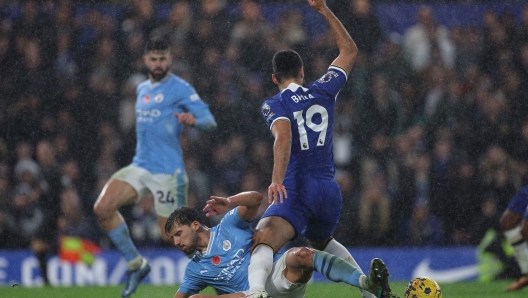 TOPSHOT - Chelsea's Albanian striker #19 Armando Broja is fouled by Manchester City's Portuguese defender #03 Ruben Dias for a late penalty to Chelsea during the English Premier League football match between Chelsea and Manchester City at Stamford Bridge in London on November 12, 2023. (Photo by Adrian DENNIS / AFP) / RESTRICTED TO EDITORIAL USE. No use with unauthorized audio, video, data, fixture lists, club/league logos or 'live' services. Online in-match use limited to 120 images. An additional 40 images may be used in extra time. No video emulation. Social media in-match use limited to 120 images. An additional 40 images may be used in extra time. No use in betting publications, games or single club/league/player publications. /