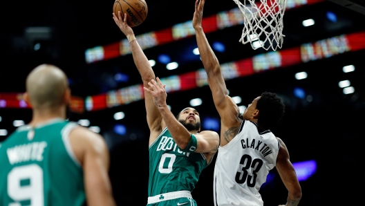 NEW YORK, NEW YORK - FEBRUARY 13: Jayson Tatum #0 of the Boston Celtics goes to the basket as Nic Claxton #33 of the Brooklyn Nets defends during the second half at Barclays Center on February 13, 2024 in the Brooklyn borough of New York City. The Celtics won 118-110. NOTE TO USER: User expressly acknowledges and agrees that, by downloading and or using this photograph, User is consenting to the terms and conditions of the Getty Images License Agreement.   Sarah Stier/Getty Images/AFP (Photo by Sarah Stier / GETTY IMAGES NORTH AMERICA / Getty Images via AFP)