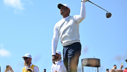 (FILES) US golfer Tiger Woods reacts to his drive from the 14th tee during his second round on day 2 of The 150th British Open Golf Championship on The Old Course at St Andrews in Scotland on July 15, 2022. Tiger Woods announced January 8, 2024 that he was ending a longstanding partnership with Nike, thanking the sports brand in a social media post that alluded to "another" unspecified chapter. (Photo by Glyn KIRK / AFP) / RESTRICTED TO EDITORIAL USE