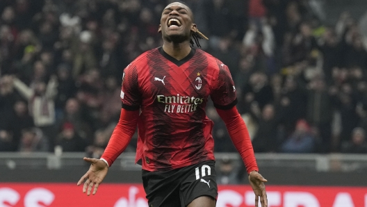 AC Milan's Rafael Leao celebrates after scoring his side's third goal during the Europa League play-off first leg soccer match between AC Milan and Rennes at the San Siro Stadium, in Milan, Italy, Thursday, Feb. 15, 2024. (AP Photo/Antonio Calanni)