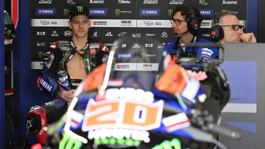 Monster Energy Yamaha's French rider Fabio Quartararo (L) sits inside his team garage during the first day of the pre-season MotoGP test at the Sepang International Circuit in Sepang on February 6, 2024. (Photo by Mohd RASFAN / AFP)