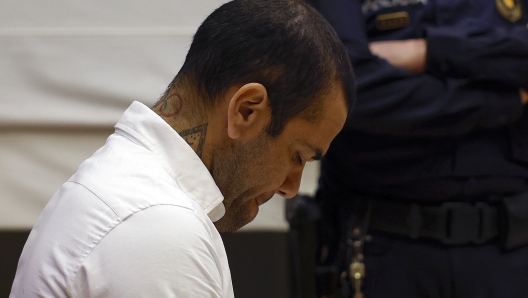 (FILES) Brazilian footballer Dani Alves looks down during his trial at the High Court of Justice of Catalonia in Barcelona, on February 5, 2024. Ex-Brazil star Dani Alves has been sentenced to 4.5 years in jail for rape, Barcelona's court announced on February 22, 2024. (Photo by ALBERTO ESTÉVEZ / POOL / AFP)