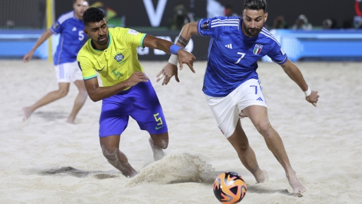 Filipe of Brazil and Fabio Sciacca competes for the ball during the FIFA Beach Soccer World Cup UAE 2024 final match between Brazil and Italy at the Dubai Design District Stadium in Dubai, United Arab Emirates, Sunday, Feb. 25, 2024. (AP Photo/Christopher Pike)