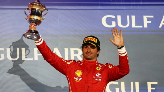 BAHRAIN, BAHRAIN - MARCH 02: Third placed Carlos Sainz of Spain and Ferrari celebrates on the podium during the F1 Grand Prix of Bahrain at Bahrain International Circuit on March 02, 2024 in Bahrain, Bahrain. (Photo by Clive Rose/Getty Images)