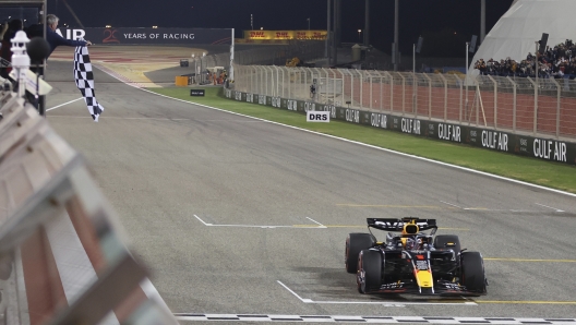 The checkered flag is waved as Red Bull driver Max Verstappen of the Netherlands crosses the finish line to take first place during the Formula One Bahrain Grand Prix at the Bahrain International Circuit in Sakhir, Bahrain, Saturday, March 2, 2024. (Ali Haider, Pool Photo via AP)