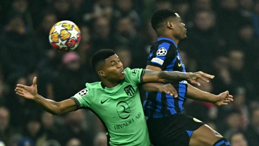 Atletico Madrid's Mozambican defender #23 Reinildo Mandava (L) fights for the ball with Inter Milan's Dutch defender #02 Denzel Dumfries during the UEFA Champions League last 16 first leg football match Inter Milan vs Atletico Madrid at the San Siro stadium in Milan on February 20, 2024. (Photo by GABRIEL BOUYS / AFP)