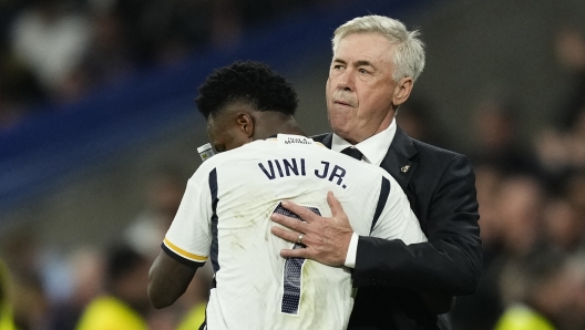 Real Madrid's Vinicius Junior celebrates with Real Madrid's head coach Carlo Ancelotti, right, after scoring his side's third goal during the Spanish La Liga soccer match between Real Madrid and Valencia at the Santiago Bernabeu stadium in Madrid, Spain, Saturday, Nov. 11, 2023. (AP Photo/Jose Breton)