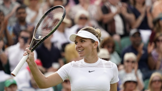 FILE Romania's Simona Halep celebrates after beating Poland's Magdalena Frech in their women's third round singles match on day six of the Wimbledon tennis championships in London, Saturday, July 2, 2022. Two-time Grand Slam champion Simona Halep has been cleared for an immediate return to tennis after sports? highest court cut her ban for doping on appeal. (AP Photo/Alberto Pezzali, File)