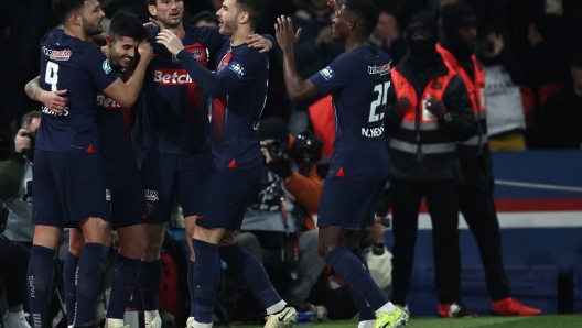 Saint-Germain's Brazilian midfielder #35 Lucas Beraldo (2L) celebrates with his teammates after scoring his team third goal during the French Cup (Coupe de France) quarter-final football match between Paris Saint-Germain (PSG) and OGC Nice at the Parc des Princes stadium, in Paris, on March 13, 2024. (Photo by FRANCK FIFE / AFP)