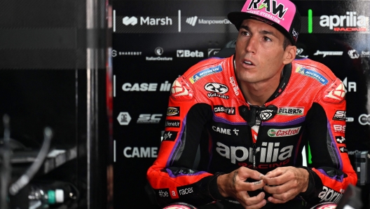 Aprilia Racing's Spanish rider Aleix Espargaro sits in the garage before the second free practice session ahead of the Indian MotoGP Grand Prix at the Buddh International Circuit in Greater Noida on the outskirts of New Delhi, on September 23, 2023. (Photo by Money SHARMA / AFP)