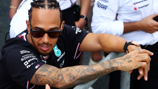 JEDDAH, SAUDI ARABIA - MARCH 09: Lewis Hamilton of Great Britain and Mercedes watches the podium celebrations during Round 1 Jeddah race 2 of the F1 Academy at Jeddah Corniche Circuit on March 09, 2024 in Jeddah, Saudi Arabia. (Photo by Clive Rose/Getty Images)