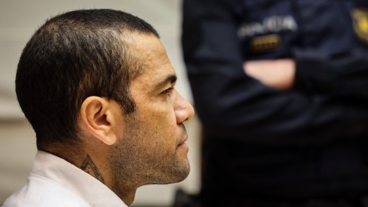 (FILES) Brazilian footballer Dani Alves looks on at the start of his trial at the High Court of Justice of Catalonia in Barcelona, on February 5, 2024. Convicted of rape, ex-Brazil star Dani Alves will be freed on bail for 1 mn euros, the court has ruled on March 20, 2024. Ex-Brazil star has been sentenced to 4.5 years in jail for rape on February 22, 2024. (Photo by Jordi BORRAS / POOL / AFP)