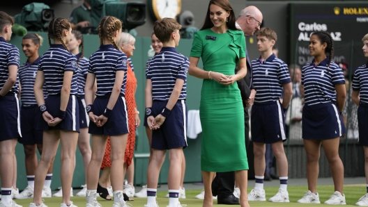 Kate, Princess of Wales greets ballboys and ballgirls as she arrives for the presentation ceremony for the final of the men's singles on day fourteen of the Wimbledon tennis championships in London, Sunday, July 16, 2023. (AP Photo/Kirsty Wigglesworth)