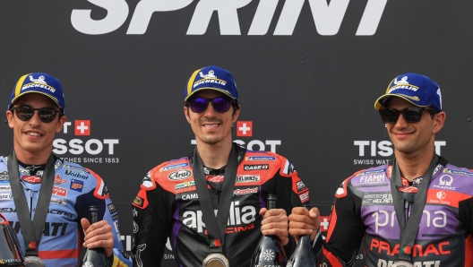 Winner Aprilia Spanish rider Maverick Vinales (C), second-placed Ducati Spanish rider Marc Marquez and third-placed Ducati Spanish rider Jorge Martin pose for pictures after the MotoGP sprint race of the Portuguese Grand Prix at the Algarve International Circuit in Portimao on March 23, 2024. (Photo by PATRICIA DE MELO MOREIRA / AFP)