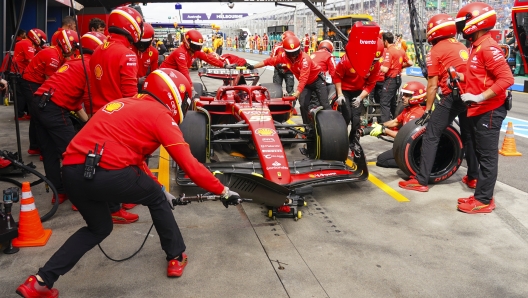 Mechanics for Ferrari driver Charles Leclerc of Monaco change his tires during the third practice session of the Australian Formula One Grand Prix at Albert Park, in Melbourne, Australia, Saturday, March 23, 2024. (AP Photo/Scott Barbour)