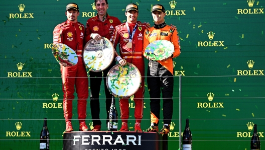 epa11240537 (L-R) Second-placed Ferrari's Charles Leclerc of Monaco, Ferrari engineer Mateo Togninalli, first-placed Carlos Sainz of Spain, and third-placed McLaren's Lando Norris of Britain celebrate on the podium following the Australian Grand Prix 2024 at Albert Park Circuit in Melbourne, Australia 24 March 2024.  EPA/JOEL CARRETT AUSTRALIA AND NEW ZEALAND OUT