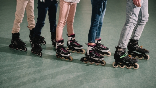 Cropped shot of several kids skating on rink