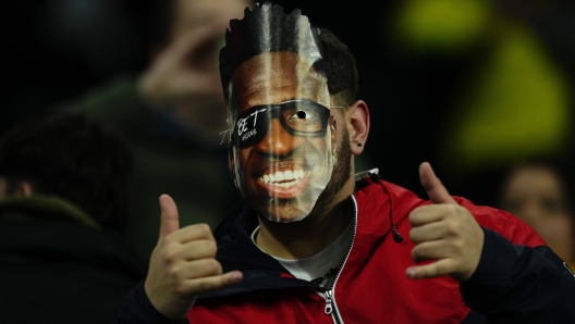 A Brazilian fan wearing a Vinicius Jr. mask gives the thumbs up before the start of a friendly soccer match between Spain and Brazil at the Santiago Bernabeu stadium in Madrid, Spain, Tuesday, March 26, 2024. (AP Photo/Jose Breton)