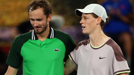 MELBOURNE, AUSTRALIA - JANUARY 28: Daniil Medvedev and Jannik Sinner of Italy embrace at the net after their Men's Singles Final match during the 2024 Australian Open at Melbourne Park on January 28, 2024 in Melbourne, Australia. (Photo by Graham Denholm/Getty Images)