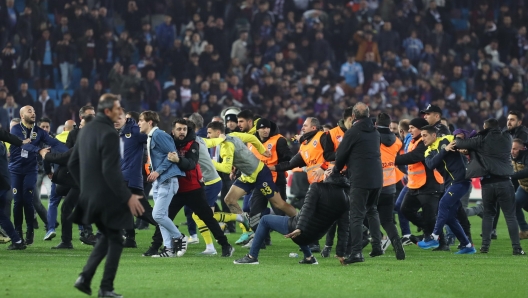 epa11226900 Trabzonspor fans attack Fenerbahce players after the Super League match between Trabzonspor and Fenerbahce in Trabzon, Turkey, 17 March 2024. After Fenerbahce won the match 3-2 against Trabzonspor fans entered the field and began chasing away Fenerbahce players.  EPA/STR