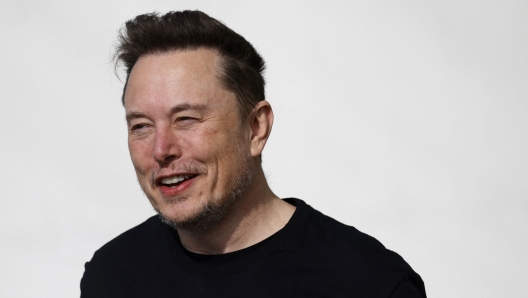 Tesla CEO Elon Musk is pictured during a visit at the company's electric car plant in Gruenheide near Berlin, eastern Germany, on March 13, 2024, as employees resumed work after production had to be halted due to a suspected arson attack that caused a power outage. Damage to the lines knocked out power to the plant as well as cutting electricity to surrounding villages since power lines supplying the factory were set on fire in the early hours of March 5, 2024. Far-left activists from the "Vulkangruppe" (Volcano Group) have claimed responsibility for the sabotage, saying they aimed to achieve "the biggest possible blackout of the gigafactory", a reference to the Tesla plant. (Photo by Odd ANDERSEN / AFP)