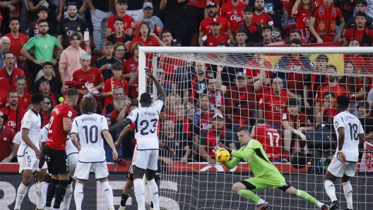 Real Madrid's goalkeeper Andriy Lunin makes a save during a Spanish La Liga soccer match between Mallorca and Real Madrid at the Son Moix stadium in Palma de Mallorca, Spain, Saturday, April 13, 2024. (AP Photo/Francisco Ubilla)