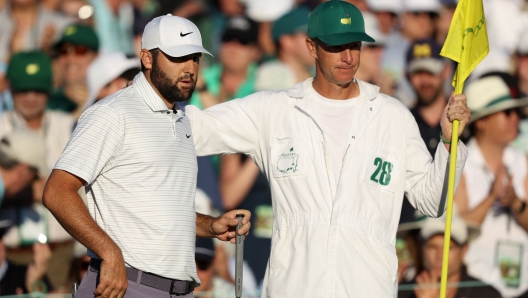 AUGUSTA, GEORGIA - APRIL 13: Scottie Scheffler of the United States and caddie Ted Scott line up a putt on the 18th green during the third round of the 2024 Masters Tournament at Augusta National Golf Club on April 13, 2024 in Augusta, Georgia.   Warren Little/Getty Images/AFP (Photo by Warren Little / GETTY IMAGES NORTH AMERICA / Getty Images via AFP)