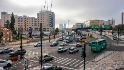 People drive along a street in Jerusalem on April 14, 2024. Iran's unprecedented attack on Israel has been "foiled," the Israeli army announced on April 14, with almost all of the more than 200 missiles and drones intercepted with the help of the United States and allies. (Photo by Menahem Kahana / AFP)