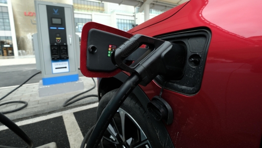 epa11264982 An electric car is charged at an electric vehicle charging station, in Hanoi, Vietnam, 08 April 2024. Vietnam expects to bring net greenhouse gas emissions to zero by 2050, with motor vehicles converting into green energy transportation.  EPA/LUONG THAI LINH