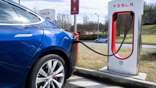 (FILES) A Tesla Model S sedan is plugged into a Tesla Supercharger electrical vehicle charging station in Falls Church, Virginia, February 13, 2023. Tesla reported an 8.5 percent drop in first-quarter auto deliveries on April 2, 2024, missing estimates from leading analysts and weighing on shares. Elon Musk's auto giant reported 386,810 deliveries over the period, reflecting in part a weak market in China, where it faces heavy competition from local electric vehicle makers. Shares fell 5.8 percent in early trading. (Photo by SAUL LOEB / AFP)