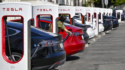 Drivers charge their Teslas in Santa Ana, Calif., on Wednesday, March 20, 2024. The Biden administration on Wednesday, March 20, 2024, issued one of the most significant climate regulations in the nation's history, a rule designed to ensure that the majority of new passenger cars and light trucks sold in the United States are all-electric or hybrids by 2032. (Jeff Gritchen/The Orange County Register via AP)