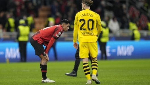 AC Milan's Tijjani Reijnders, left, reacts at the end of the Champions League group F soccer match between AC Milan and Borussia Dortmund at the San Siro stadium in Milan, Italy, Tuesday, Nov. 28, 2023. Borussia Dortmund won 3-1. (AP Photo/Antonio Calanni)