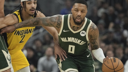 Milwaukee Bucks' Damian Lillard gets past Indiana Pacers' Andrew Nembhard during the first half of Game 1 of the NBA playoff basketball game Sunday, April 21, 2024, in Milwaukee. (AP Photo/Morry Gash)