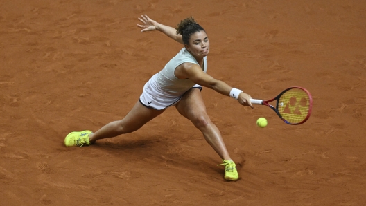 Italy's Jasmine Paolini returns a shot during her quarterfinals tennis match against Kazakhstan's Elena Rybakina at the WTA Tour in Stuttgart, Germany, Friday April 19, 2024. (Marijan Murat/dpa via AP)