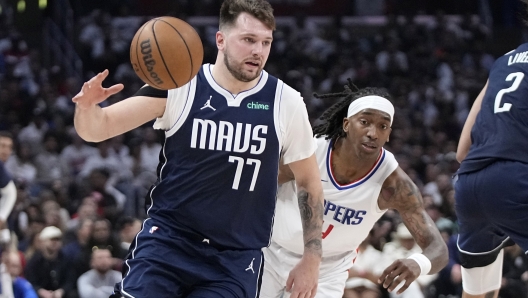 Dallas Mavericks guard Luka Doncic, left, dries toward the basket as Los Angeles Clippers guard Brandon Boston Jr. follows during the second half in Game 5 of an NBA basketball first-round playoff series Wednesday, May 1, 2024, in Los Angeles. (AP Photo/Mark J. Terrill)