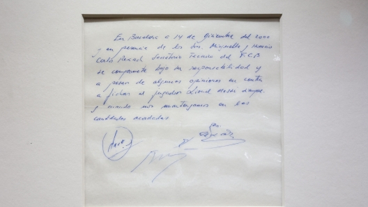 A photograph taken on May 8, 2024 shows the napkin on which the 13-year-old Argentinian football player Lionel Messi was promised his first contract with FC Barcelona, during a photocall at Bonhams, in London, ahead of its auction. The original napkin in blue ink is being offered at Bonhams on behalf of Argentine agent, Horacio Gaggioli, in an online auction starting on 8th and running until 17th May. The starting price is £300,000. (Photo by Adrian DENNIS / AFP)