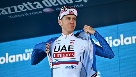 Slovenian rider Tadej Pogacar of Uae Emirates team retaining the best climber's blue jersey celebrate on the podium after 9th stage of the 107 Giro d'Italia 2024, cycling race over 214 km from Avezzano to Napoli, Italy, 12 May 2024. ANSA/LUCA ZENNARO