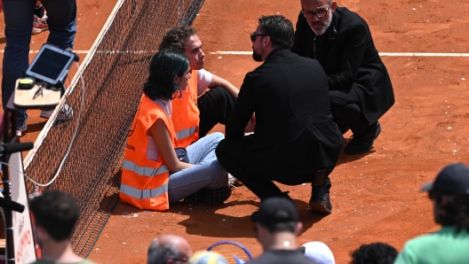 ROME, ITALY - MAY 13: Protesters block the court during the  Men's Doubles Round of 16 match between Marcelo Arevalo of El Salvador and Mate Pavic of Croatia and Santiago Gonzalez of Mexico and Edouard Roger-Vasselin of France on Day Eight of Internazionali BNL D'Italia at Foro Italico on May 13, 2024 in Rome, Italy. (Photo by Mike Hewitt/Getty Images)