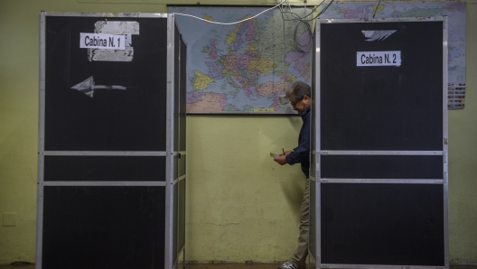 ROME, ITALY - SEPTEMBER 25: A man leaves the voting booth to cast his vote in the Italian general election on September 25, 2022 in Rome, Italy. The snap election was triggered by the resignation of Prime Minister Mario Draghi in July, following the collapse of his big-tent coalition of leftist, right-wing and centrist parties. (Photo by Antonio Masiello/Getty Images)