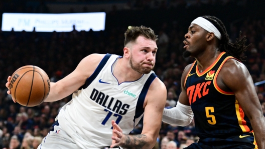 OKLAHOMA CITY, OKLAHOMA - MAY 15: Luka Doncic #77 of the Dallas Mavericks drives to the basket against Luguentz Dort #5 of the Oklahoma City Thunder during the second quarter in Game Five of the Western Conference Second Round Playoffs at Paycom Center on May 15, 2024 in Oklahoma City, Oklahoma. NOTE TO USER: User expressly acknowledges and agrees that, by downloading and or using this photograph, User is consenting to the terms and conditions of the Getty Images License Agreement.   Joshua Gateley/Getty Images/AFP (Photo by Joshua Gateley / GETTY IMAGES NORTH AMERICA / Getty Images via AFP)