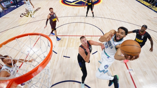 DENVER, COLORADO - MAY 19: Karl-Anthony Towns #32 of the Minnesota Timberwolves shoots the ball against Nikola Jokic #15 of the Denver Nuggets during the first half in Game Seven of the Western Conference Second Round Playoffs at Ball Arena on May 19, 2024 in Denver, Colorado. NOTE TO USER: User expressly acknowledges and agrees that, by downloading and or using this photograph, User is consenting to the terms and conditions of the Getty Images License Agreement.   C. Morgan Engel/Getty Images/AFP (Photo by C. Morgan Engel / GETTY IMAGES NORTH AMERICA / Getty Images via AFP)