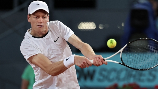 Italy's Jannik Sinner returns the ball to Italy's Lorenzo Sonego during their 2024 ATP Tour Madrid Open tournament tennis match at Caja Magica in Madrid on April 27, 2024. (Photo by Thomas COEX / AFP)