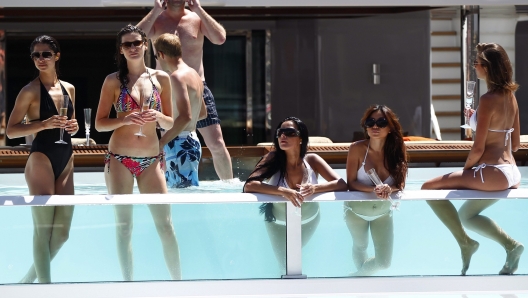 epa02757892 Spectators watch the  2011 Monaco Formula One Grand Prix race in a pool at the Monte Carlo circuit, in Monaco, 29 May 2011.  EPA/VALDRIN XHEMAJ