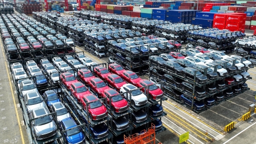 (FILES) This photo taken on September 11, 2023, shows BYD electric cars awaiting to be loaded onto a ship at the international container terminal of Taicang Port at Suzhou Port, in China’s eastern Jiangsu Province. Struggling foreign automakers in China are looking for help from local tech giants to try and stay competitive in the world's biggest electric car market, where shiny smart screens, assisted driving and sophisticated map technology are in high demand. (Photo by AFP) / China OUT / To go with China-economy-auto-technology-EVs, FOCUS by Peter Catterall and Qasim Nauman