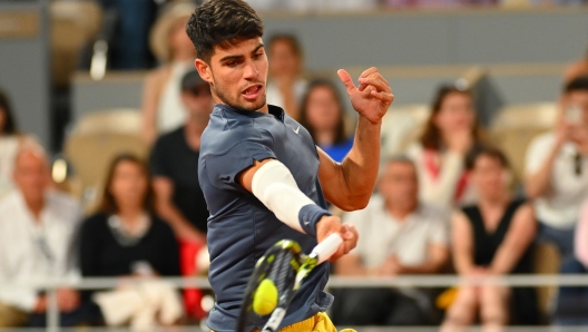 PARIS, FRANCE - MAY 26: Carlos Alcaraz of Spain plays a forehand against J.J. Wolf of United States in the Men's Singles first round match on Day One of the 2024 French Open at Roland Garros on May 26, 2024 in Paris, France. (Photo by Clive Mason/Getty Images)